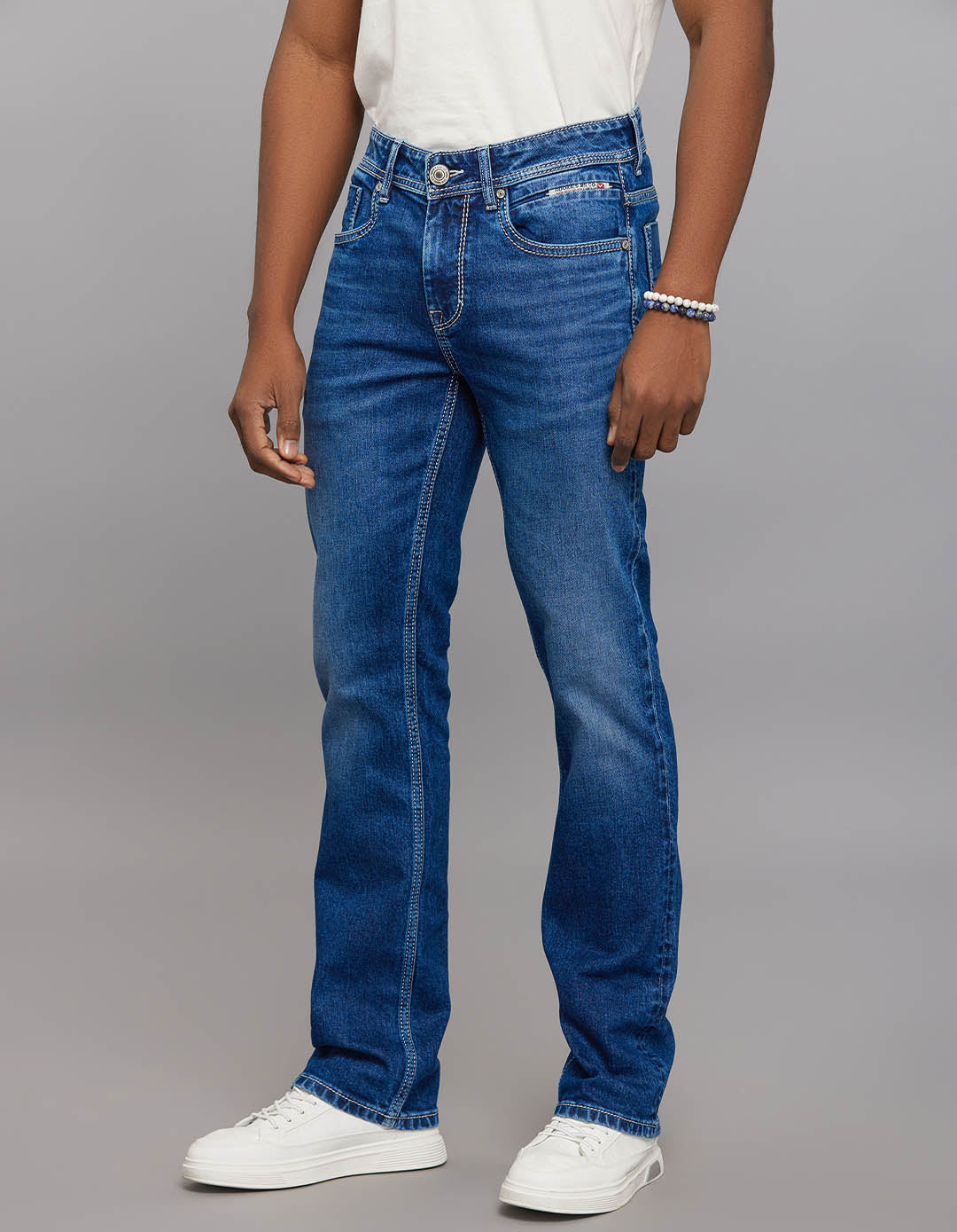 Medium Blue 5 Pocket Mid Rise Loose Boot Leg Stretch Jeans