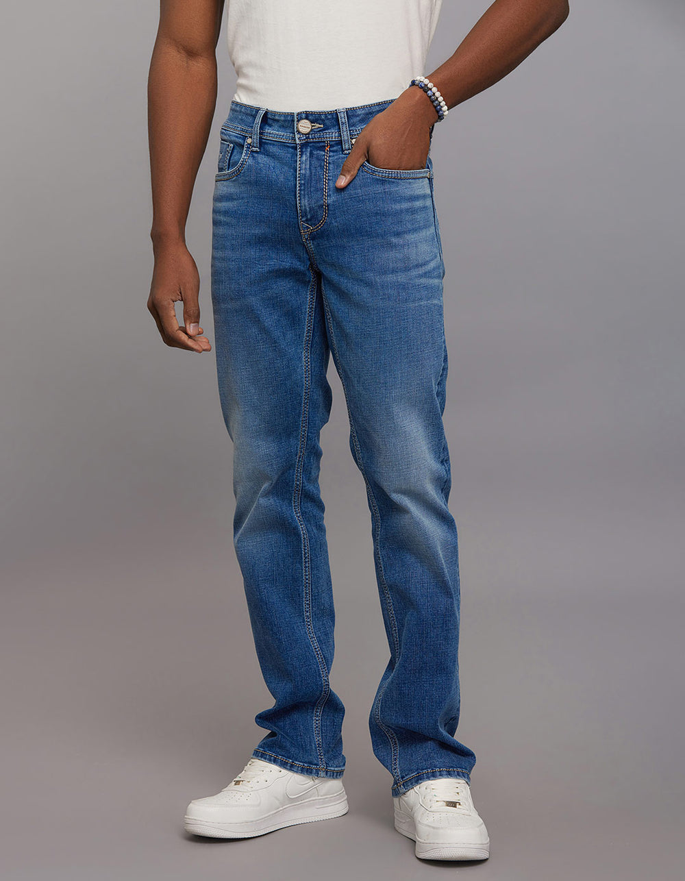 Medium Blue 5 Pocket Mid Rise Loose Boot Leg Stretch Jeans