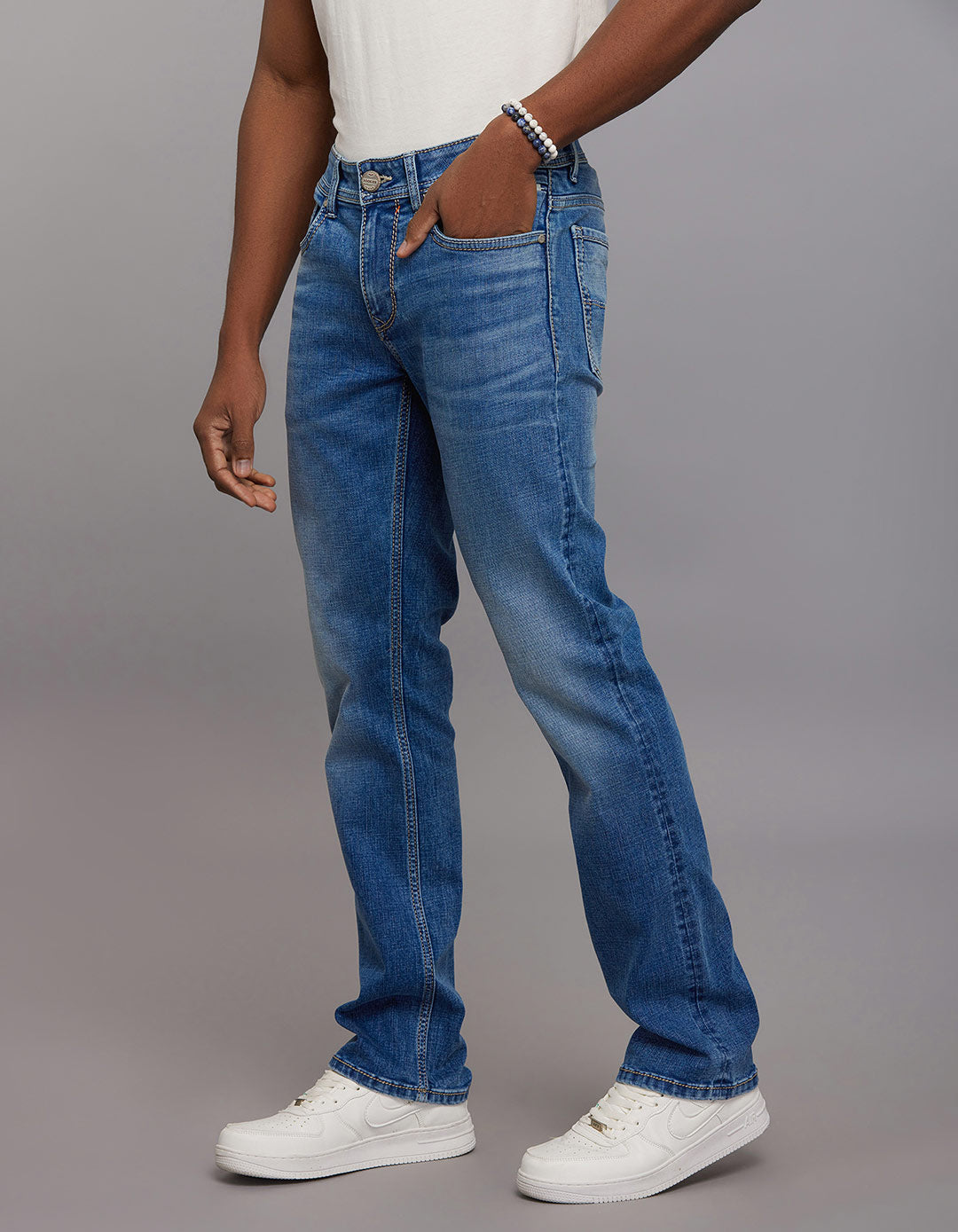 Medium Blue 5 Pocket Mid Rise Loose Boot Leg Stretch Jeans