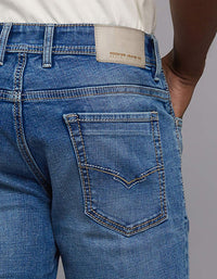 Medium Blue 5 Pocket Mid Rise Loose Boot Leg Stretch Jeans